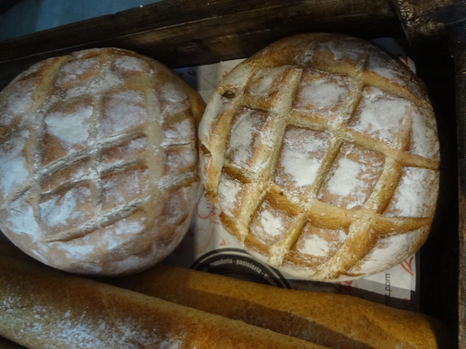Two crosshatch-scored country sourdough loaves